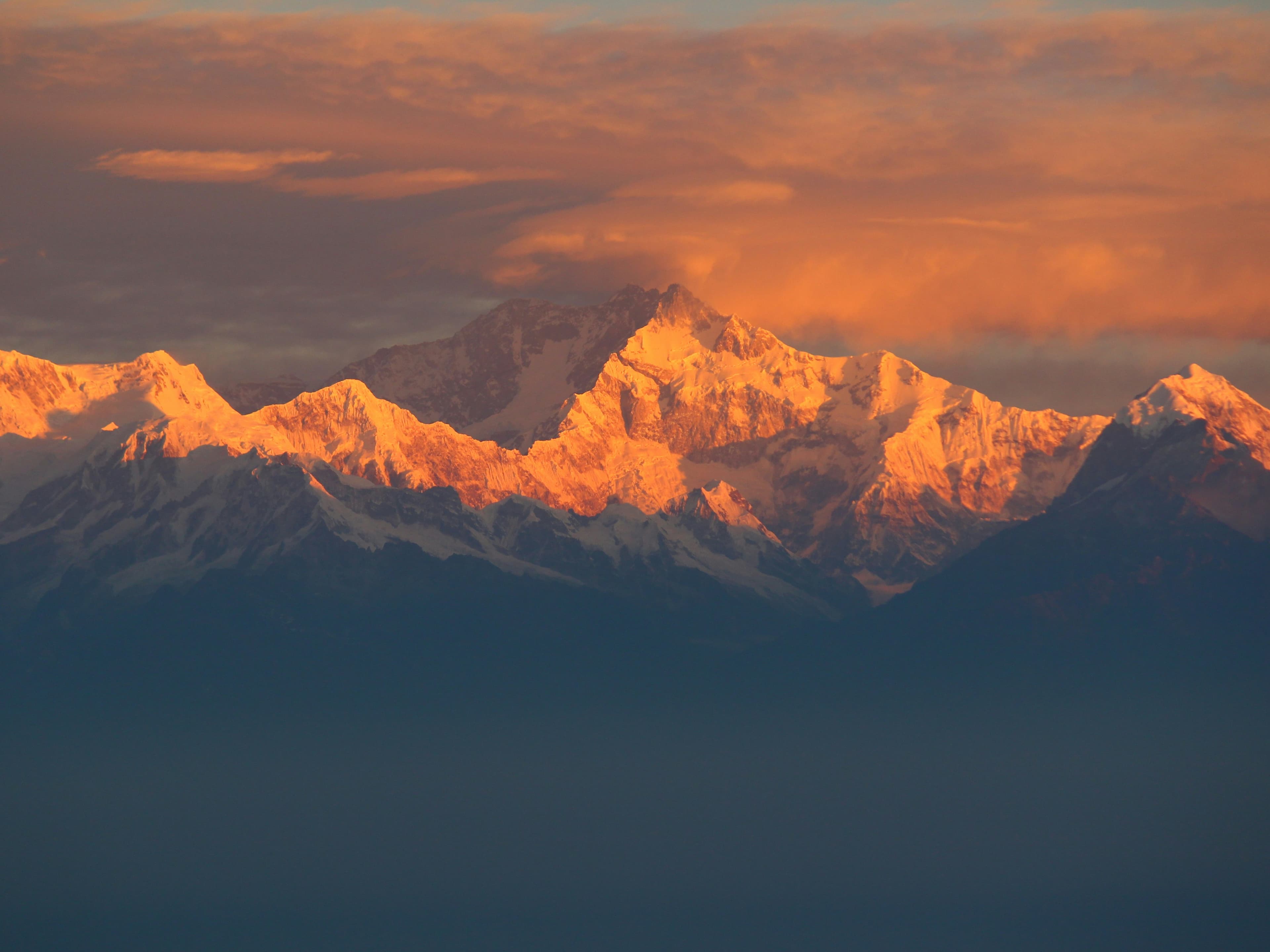 Snow-capped Himalayan peaks under a dramatic sky